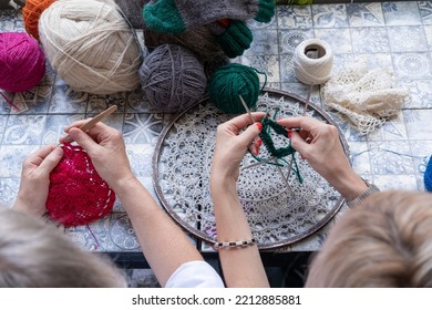 Mom And Daughter Knit Together In The Garden. Family Friendly Leisure. Elderly Mother Teaching To Crochet Adult Daughter 