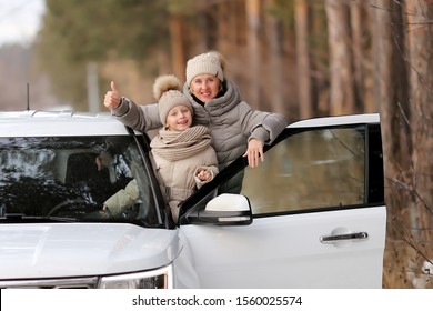 Mom And Daughter Next To A White Car