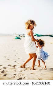 mom and daughter on the beach - Shutterstock ID 1061302160