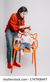 Mom And Daughter In Photo Studio Getting Ready To Shoot, Mom Combing Her Baby's Hair