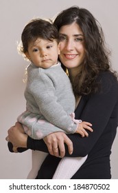 Mom And Daughter Posing In Studio Shot