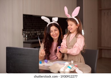 Mom And Daughter Record Egg Painting Lessons On Web Camera With Laptop