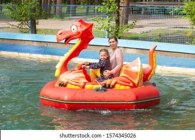 Mom And Daughter Ride On The Water Attraction 