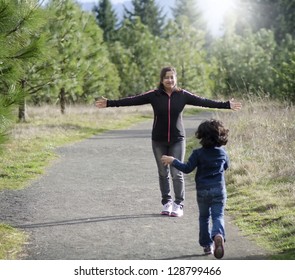 Mom And Daughter Running In A Park