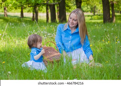 Mom And Daughter In The Same Dress In The Forest With A Basket