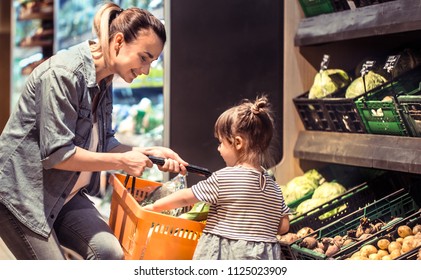 Mom And Daughter Are Shopping At The Supermarket, The Concept Of Family Relationships And Healthy Eating