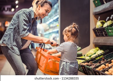 Mom And Daughter Are Shopping At The Supermarket, The Concept Of Family Relationships And Healthy Eating