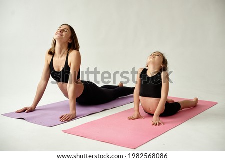 Mom and daughter spend the morning yoga practice.