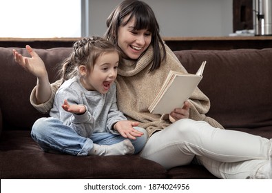 Mom and daughter spend time together reading a book. The concept of children's development and quality time. - Powered by Shutterstock