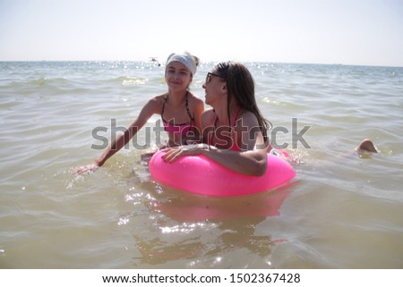 mom and daughter swim in the sea