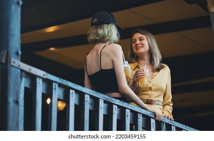 Mom And Daughter Are Talking Outdoors.