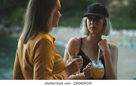 Mom And Daughter Are Talking Outdoors.