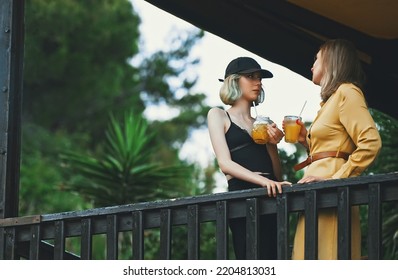 Mom And Daughter Are Talking Outdoors.