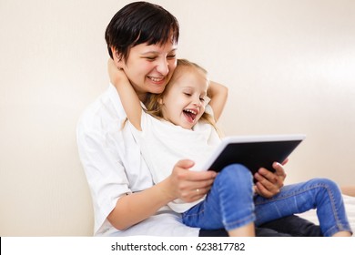 Mom and daughter using tablet