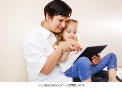 Mom And Daughter Using Tablet