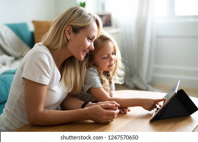 Mom and daughter watching a cartoon on a digital tablet - Powered by Shutterstock