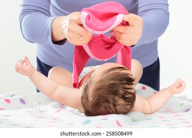 Mom Dressing Her Little Baby Girl