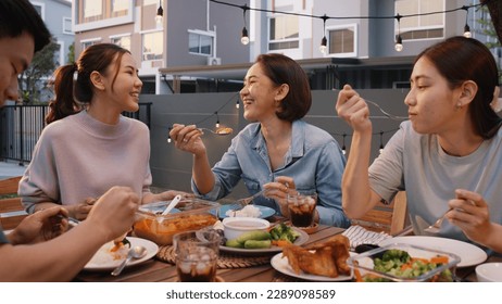 Mom enjoy thai meal cooking for family day meet talk home dining at dine table cozy patio. Group asia people young adult man woman friend fun joy relax warm night time picnic eat yummy food with mum. - Powered by Shutterstock