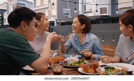 Mom enjoy thai meal cooking for family day meet talk home dining at dine table cozy patio. Group asia people young adult man woman friend fun joy relax warm night time picnic eat yummy food with mum. - Powered by Shutterstock