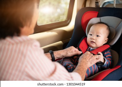 Mom Fasten His Little Baby In The Car Seat. Asian People In Car.