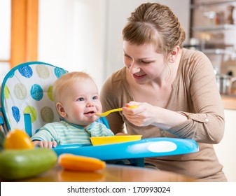 Mom Feeds Baby Boy With Spoon