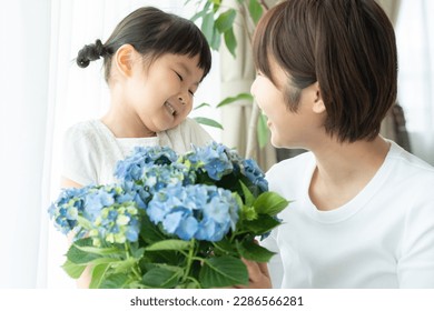 Mom gets hydrangea from child on Mother's Day - Powered by Shutterstock