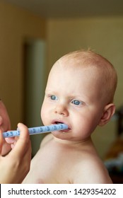 Mom Gives Her Little Child Medicine Through A Syringe