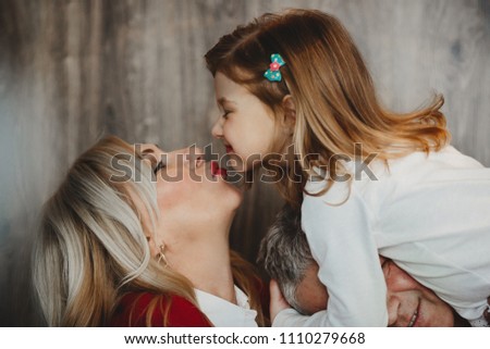 Mom gives a kiss to a charming little girl