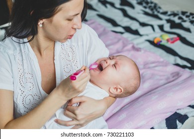 Mom Gives Medicine To A Baby