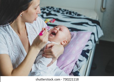 Mom Gives Medicine To A Baby