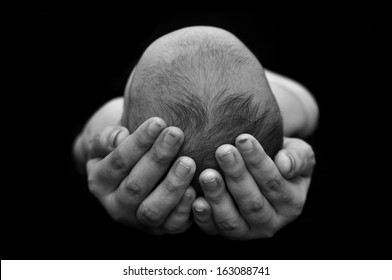 Mom Hand Hold The Baby In Black Background