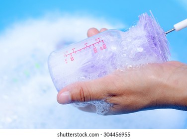 Mom Hand Washing Baby Bottle