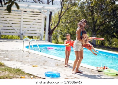 Mom and happy childrenhave fun in the pool.Family having fun and relaxing in outdoor swimming pool - Powered by Shutterstock