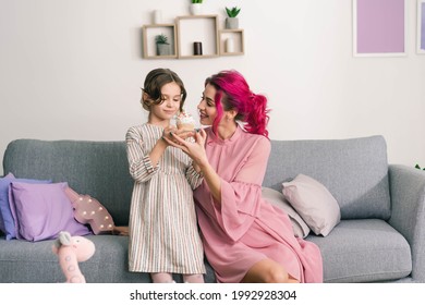 Mom Is Happy To Offer Her Daughter A Cake For Tea