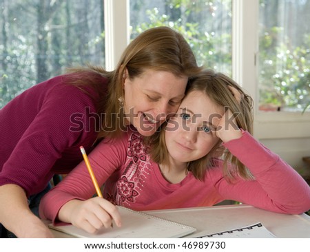 Mom helping daughter with homework