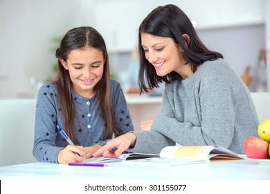 Mom helping her daughter do her homework