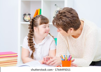 Mom Helps Daughter With Down Syndrome Read To Nigu In Class During Home Education. Affordable Education For Children With Disabilities In The Family