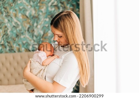 Similar – Image, Stock Photo Mother giving bottle to her newborn