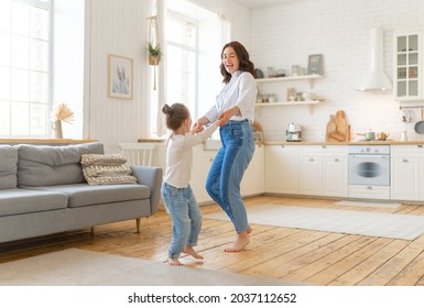 Mom and her daughter child girl are dancing. Family holiday and togetherness. - Powered by Shutterstock