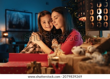 Mom and her daughter prepaaring gifts for Christmas