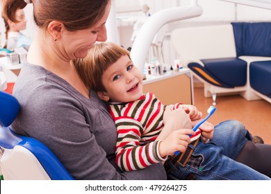 Mom and her little son visiting the dentist