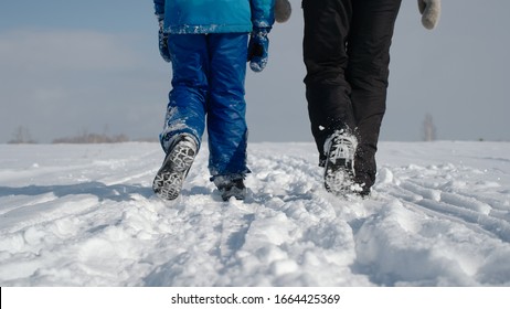 Mom And Her Son. Family Walking In The Winter Snowy Countryside