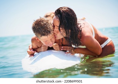 Mom With Her Teen Son Lying On A Swimming Board. Happy European Family Having Fun Floating On A Swim Board In The Sea On A Hot Summer Day