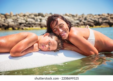 Mom With Her Teen Son Lying On A Swimming Board. Happy European Family Having Fun Floating On A Swim Board In The Sea On A Hot Summer Day