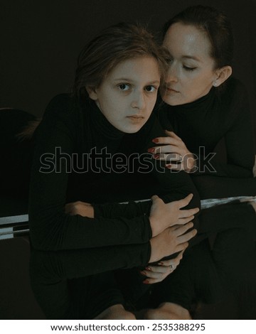 Similar – thin hands of an adult woman hugging a young girl