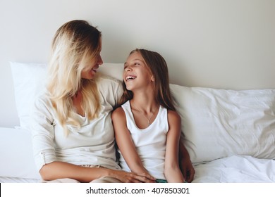 Mom With Her Tween Daughter Relaxing In Bed, Positive Feelings, Good Relations.