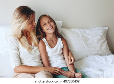 Mom With Her Tween Daughter Relaxing In Bed, Positive Feelings, Good Relations.