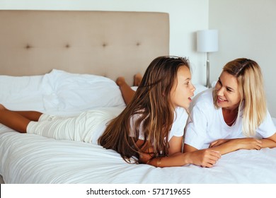 Mom With Her Tween Daughter Relaxing In Bed, Positive Feelings, Good Relations.