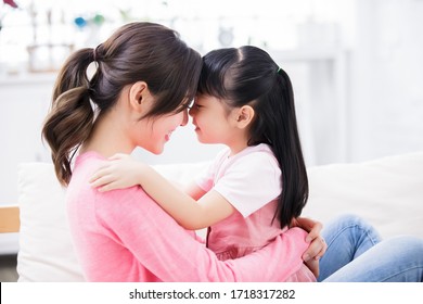 Mom Hold Daughter In Her Arm And Child Smile Happily