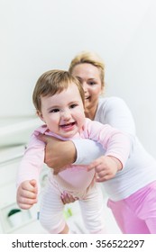 Mom Holding Baby Little Girl In Front Of The Camera.Baby Smiling At Camera.Low Angle View, Shallow Doff